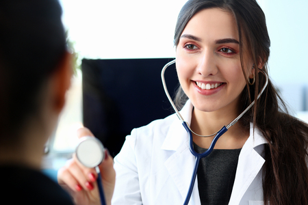 Beautiful smiling female doctor hold in armの写真素材