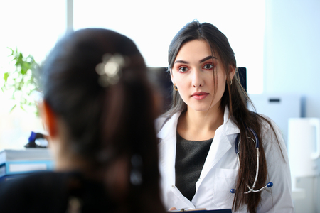 Smiling beautiful female medicine doctor explain diagnosisの写真素材