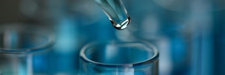 Test tube of glass overflows liquid solution potassiumの写真素材