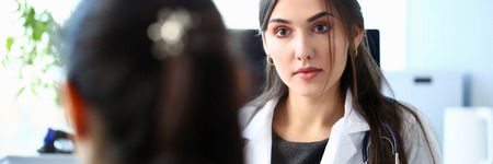 Smiling beautiful female medicine doctor explain diagnosisの写真素材