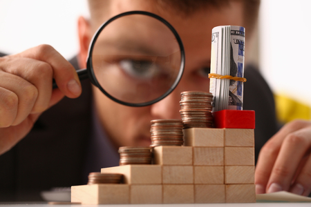 Businessman holds in hand black lensの写真素材