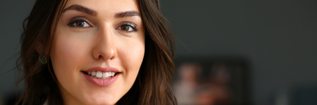 Beautiful smiling girl at workplace look in cameraの写真素材