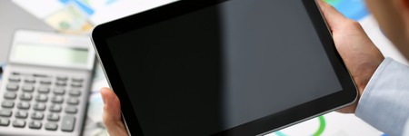 Businessman holds tablet on background