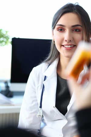 Female medicine doctor hand hold jar of pills andの写真素材