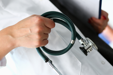 Female doctor hand hold phonendoscope in medicalの写真素材