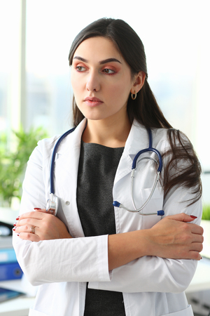 Beautiful smiling female doctor at workplace portraitの写真素材