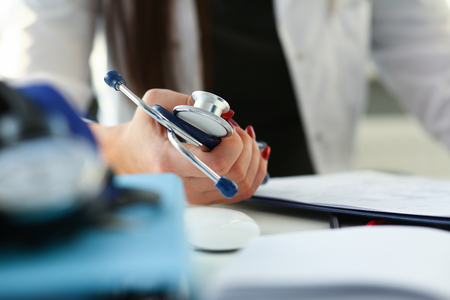 Female doctor hand hold phonendoscope in medicalの写真素材