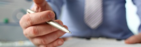 Male arm in suit offer contract form on clipboardの写真素材
