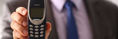 Businessman holding Nokia cellphoneのeditorial素材