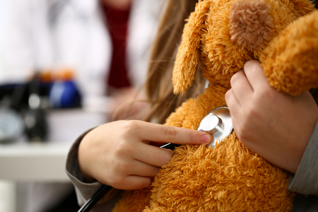 Female hand of little girl hold stethoscope listenの写真素材