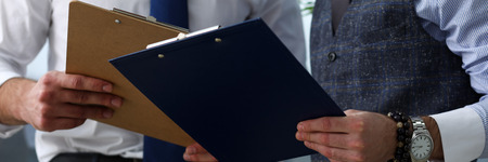 Group of people hold in arms financial papersの写真素材