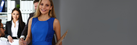 Beautiful smiling clerk girl wearing blue sundress