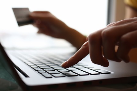 Male arms hold credit card press buttonsの写真素材