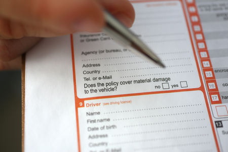 Male insurer hand hold silver pen an accidentの写真素材