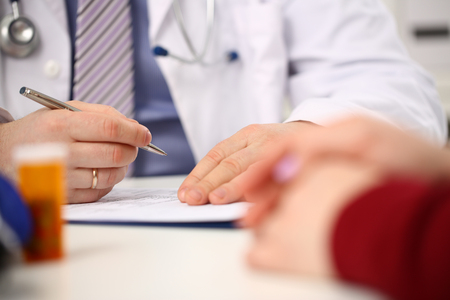 Male doctor hand hold silver pen fillingの写真素材