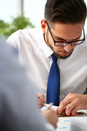 Handsome smiling bearded clerk man at office workplaceの写真素材