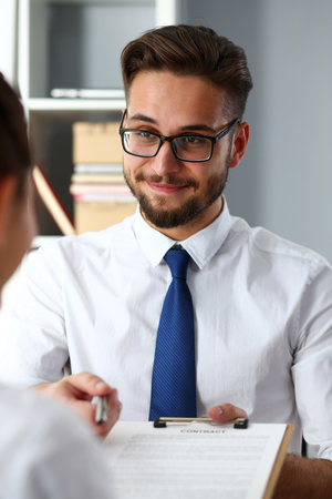 Handsome bearded man offer contract form on clipboardの写真素材