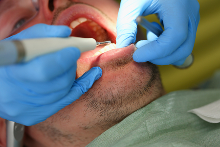 Female hand in blue protective glovesの写真素材