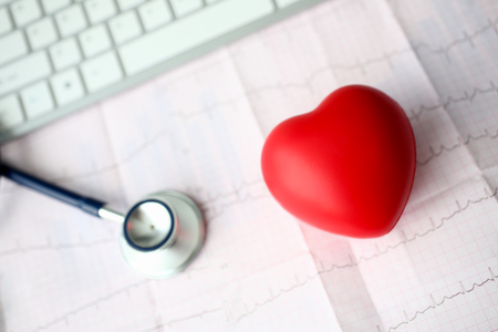 Medical stethoscope head and red toy heartの写真素材