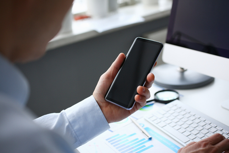 Businessman hipster holds telephone background ofの写真素材