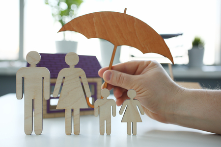 Male insurance agent hold hands gesture shieldの写真素材