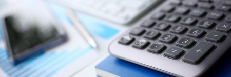 Silver calculator and financial statistics on clipboard