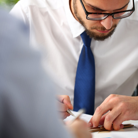 Handsome smiling bearded clerk man at office workplaceの写真素材