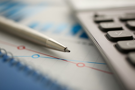 Silver calculator and financial statistics on clipboard