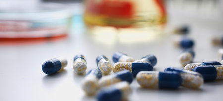 Pile of red and blue pills arranged in on whiteの写真素材