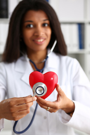 Beautiful black smiling female doctor holdの写真素材