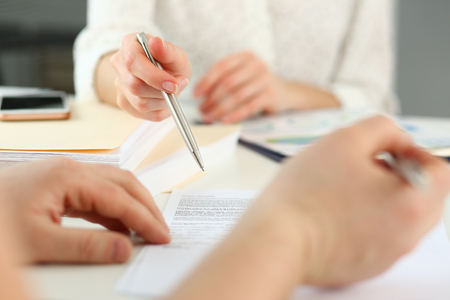 Female arm offer contract form on clipboard padの写真素材