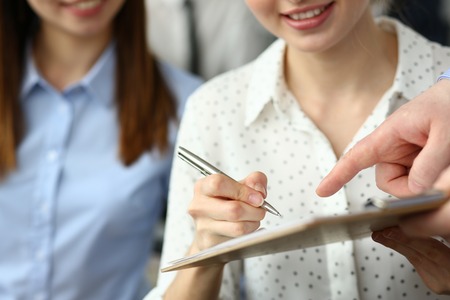 Female arm offer contract form on clipboard pad