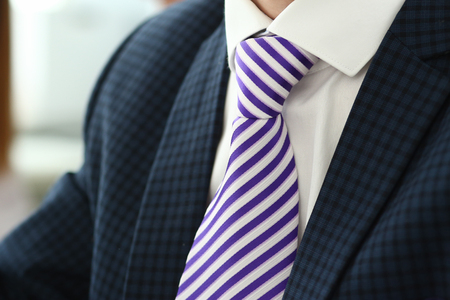 Male arm in blue suit set tie closeupの写真素材
