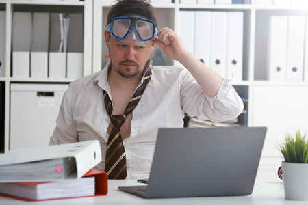 Man wearing suit and tie in goggles with snorkel