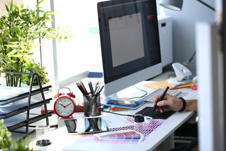 Designer male arm hold graphic pad pen working on projectの写真素材