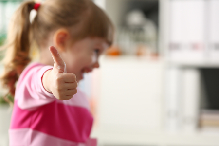Little girl show approve or OK sign with her armの写真素材