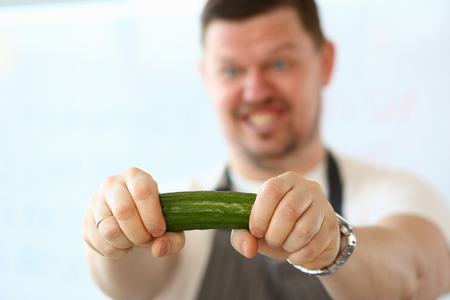 Bearded Chef Holding Green Cucumber Ingredientの写真素材