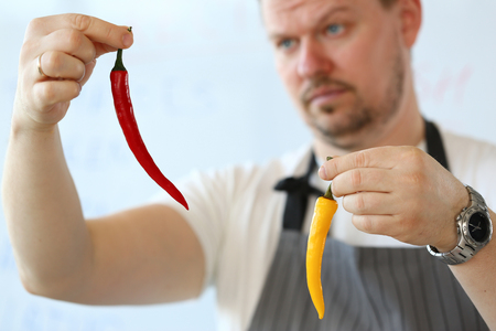 Professional Chef Showing Yellow Chili Pepperの写真素材