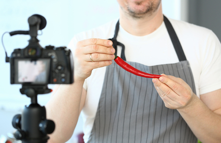 Blogger Man Recording Red Chili Pepper Recipeの写真素材