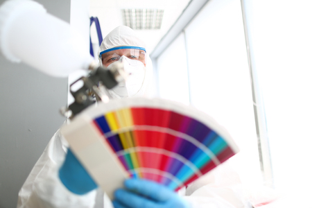 Handyman portrait olding airbrush and colorful fantailの写真素材