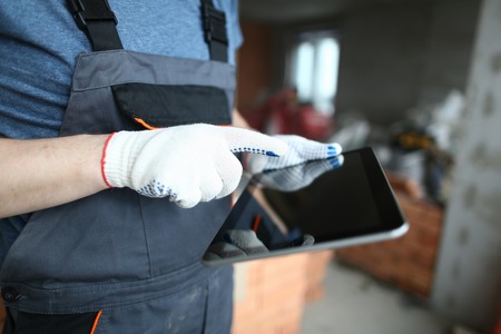 Builder holding modern tabletの写真素材