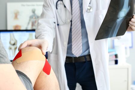 Doctor helping patient