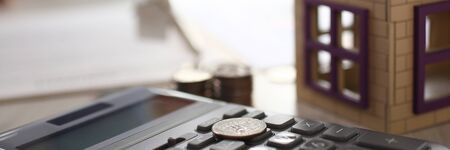 Home Keychain in Real Estate Agent Hand House Rent. Property Loan Sale Concept. House, Calculator. Bank Credit for Residential Purchaseの写真素材