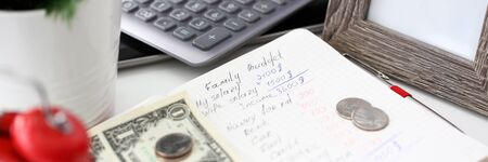 Notepad with handwritten calculations of family budgetの写真素材