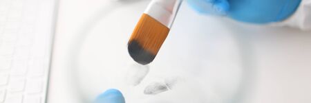 Male hand in blu protective gloves hold brush