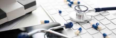 Stethoscope and Pharmaceutical Pill Lying Keyboardの写真素材