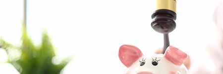 Gavel threaten to funny piggybank in time of big financial difficulties
