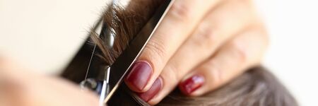 Female Fingers Trimming Male Hair by Scissorsの写真素材