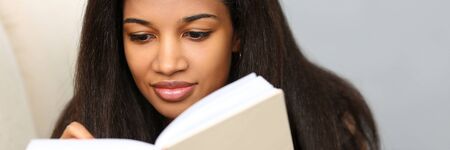 Smiling black woman write story in notebook