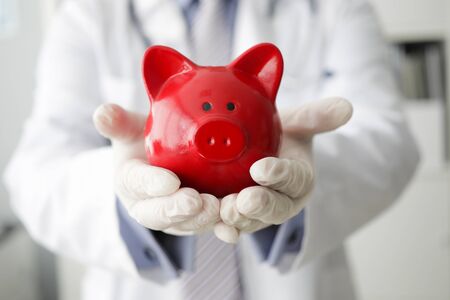 Doctor holding piggy bankの写真素材